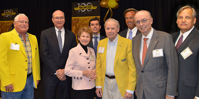 Grandsons of Monroe founders and Tenneco execs pose for a celebratory photo. From left to right: James McIntyre, Gregg Sherrill, Susan McIntyre, Enrique Orta, William McIntrye, Rick Meyer, Charles McIntrye and Joe Pomaranski.